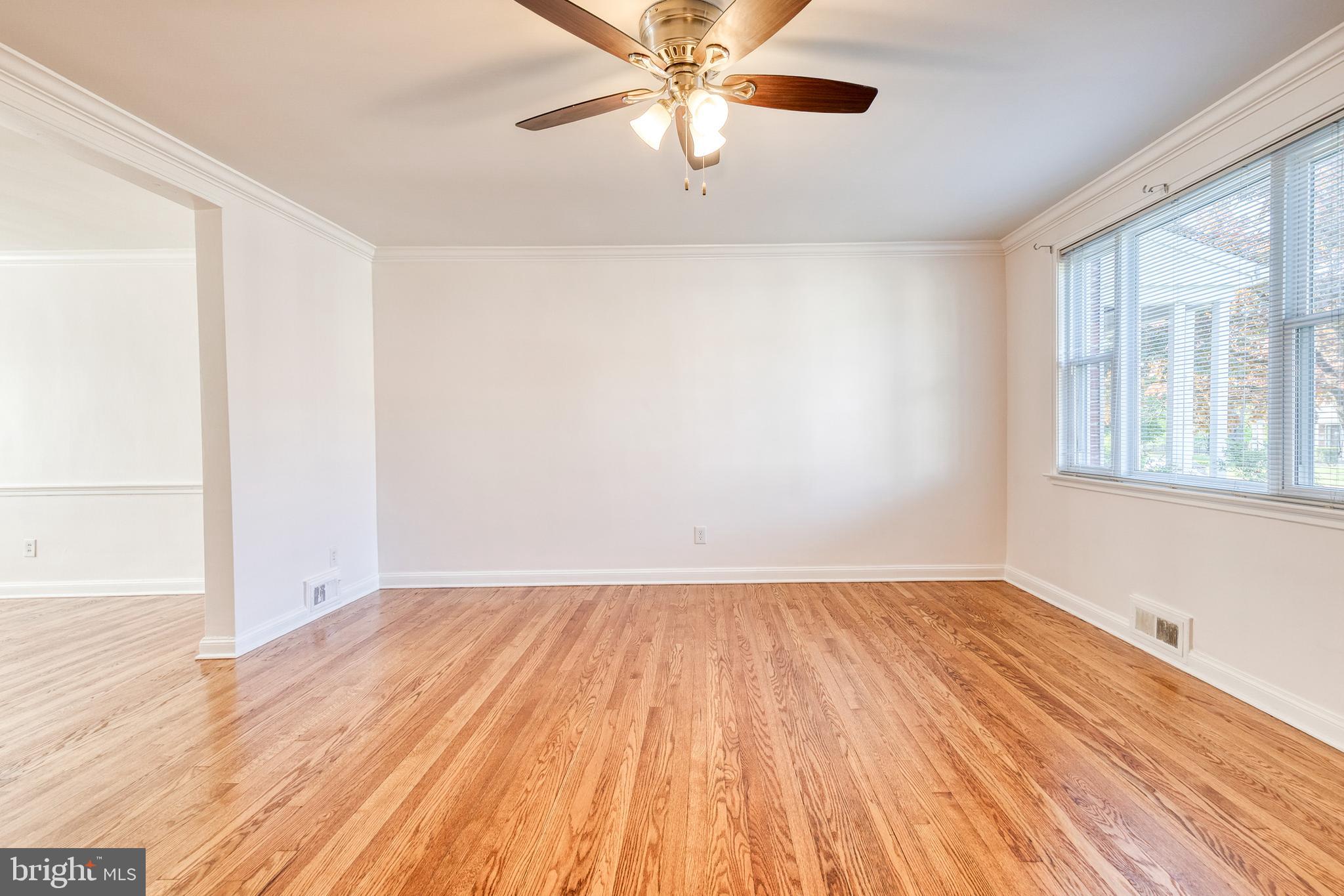 2012 Northbourne Road Baltimore, MD 21239 - Photo 11 of 35 a view of empty room with wooden floor and fan
