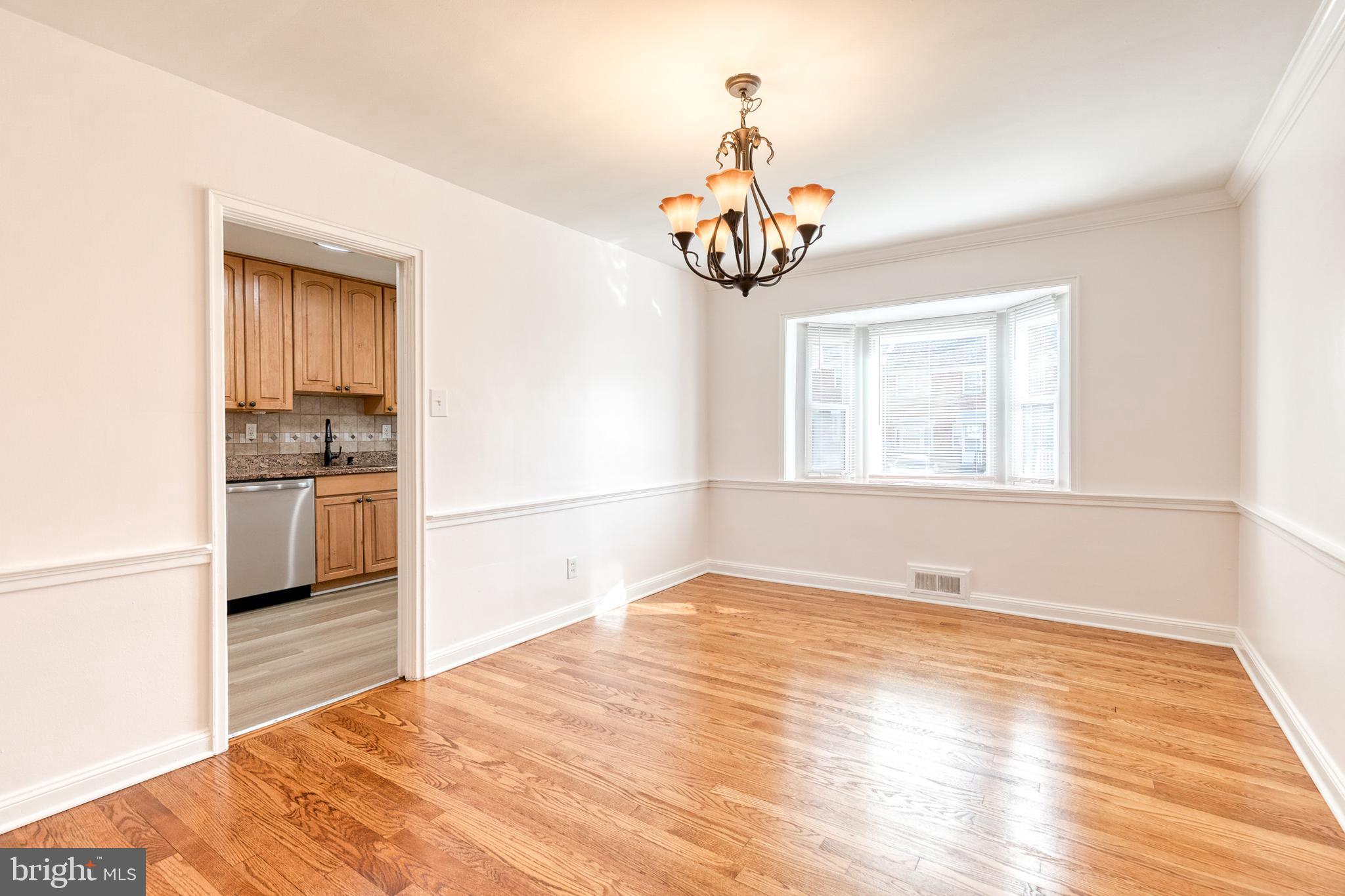 2012 Northbourne Road Baltimore, MD 21239 - Photo 14 of 35 a view of empty room with wooden floor and kitchen