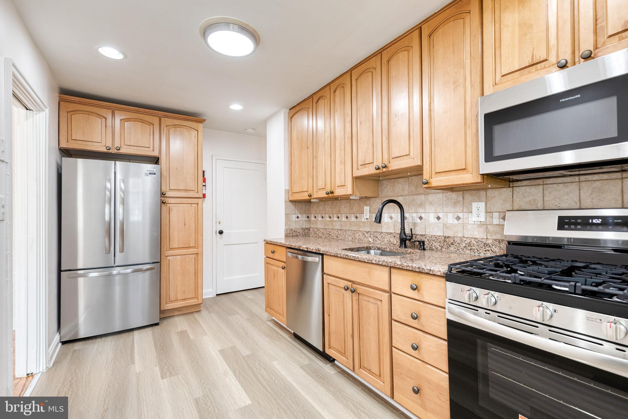 2012 Northbourne Road Baltimore, MD 21239 - Photo 21 of 35 a kitchen with stainless steel appliances granite countertop a refrigerator sink and cabinets