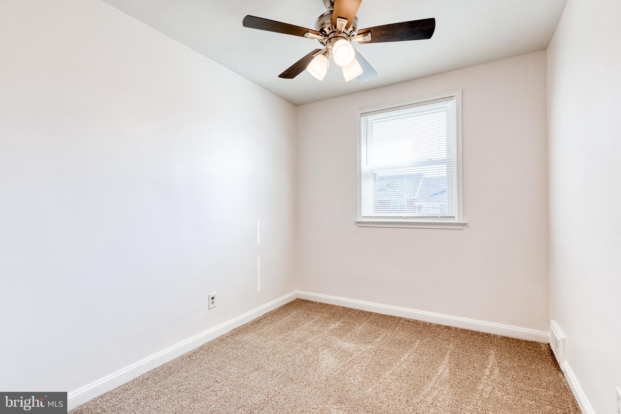 2012 Northbourne Road Baltimore, MD 21239 - Photo 23 of 35 an empty room with a window and a fan