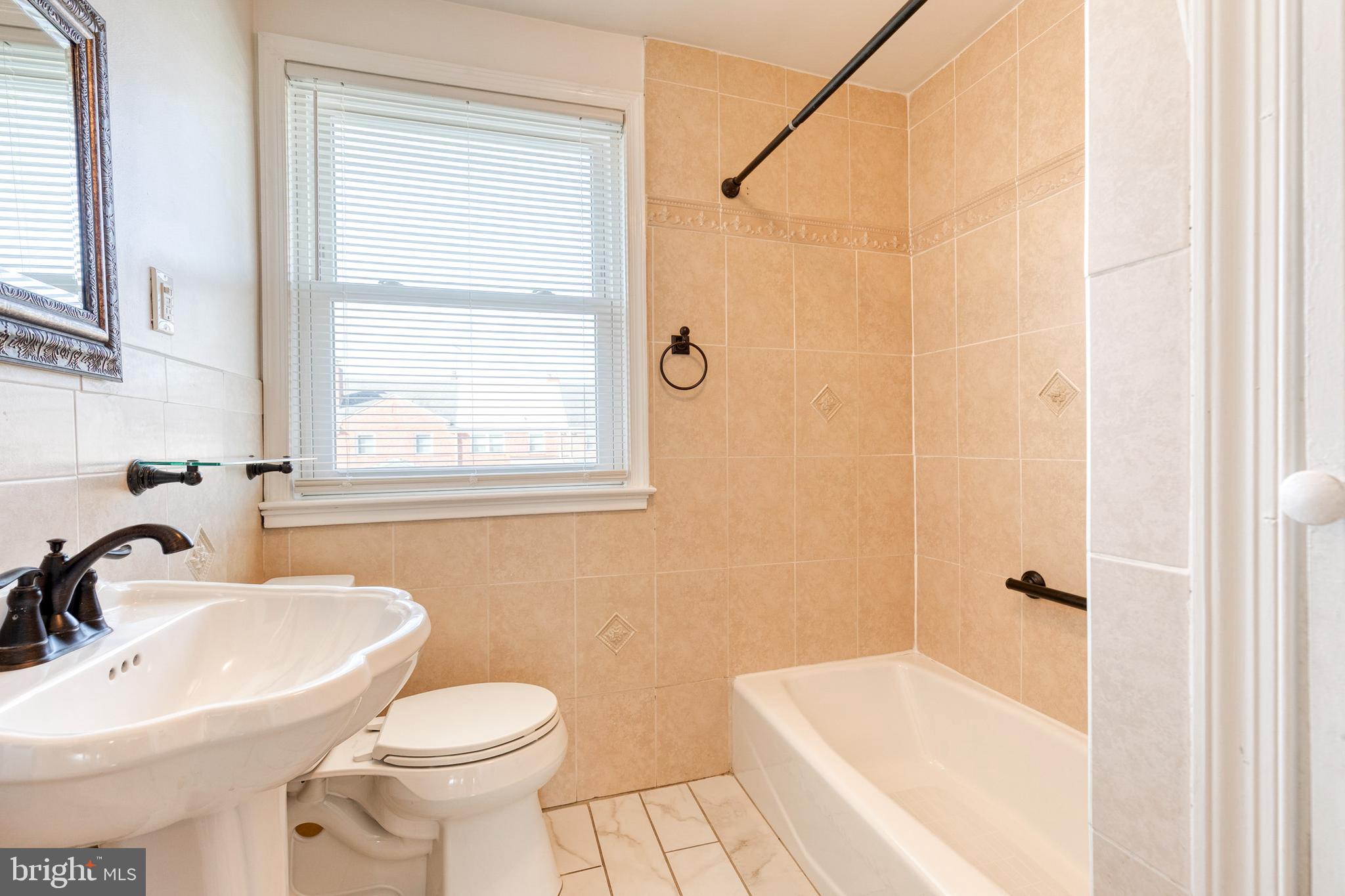 2012 Northbourne Road Baltimore, MD 21239 - Photo 28 of 35 a bathroom with a sink toilet and shower