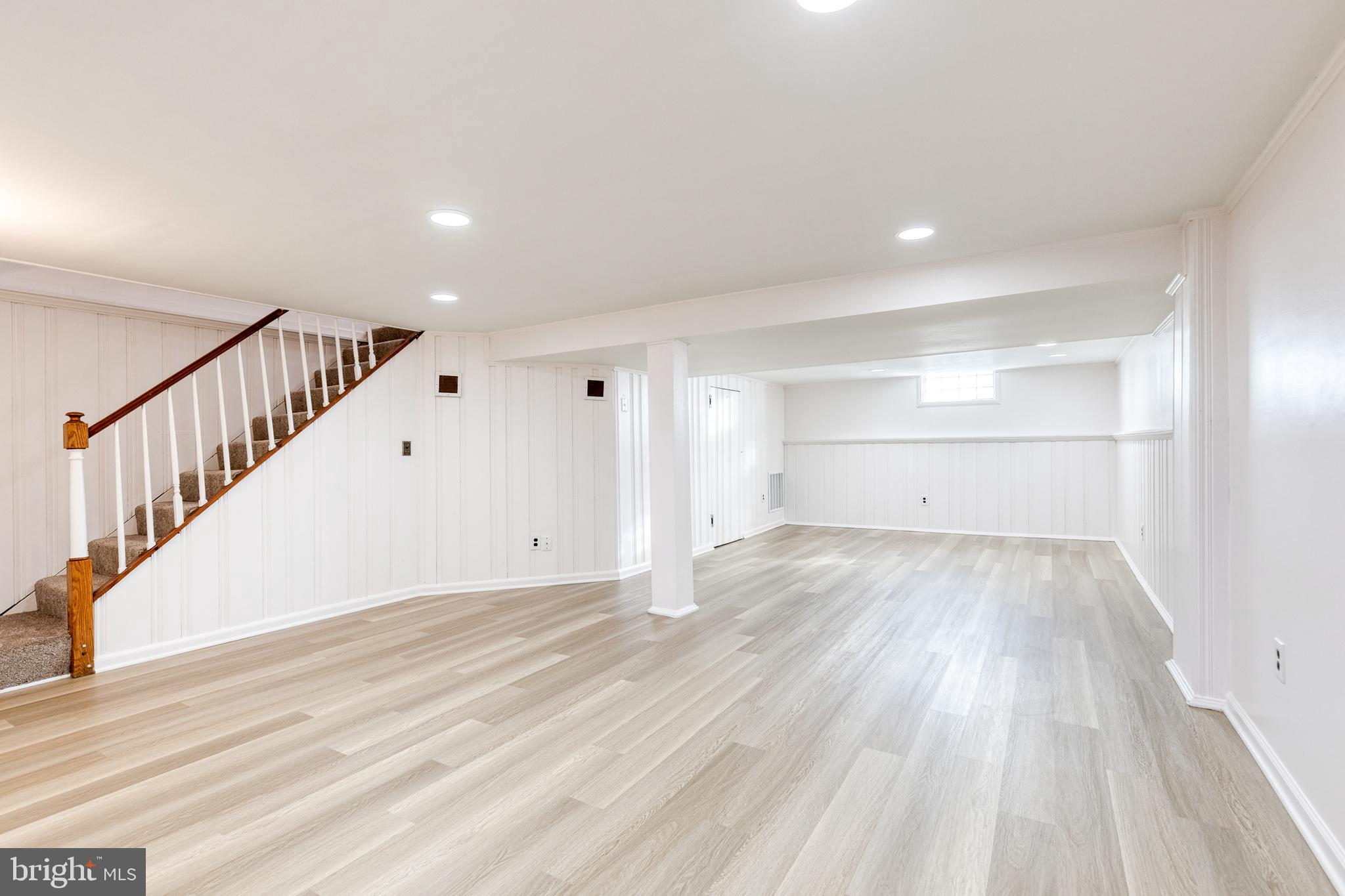 2012 Northbourne Road Baltimore, MD 21239 - Photo 32 of 35 a view of an empty room with wooden floor