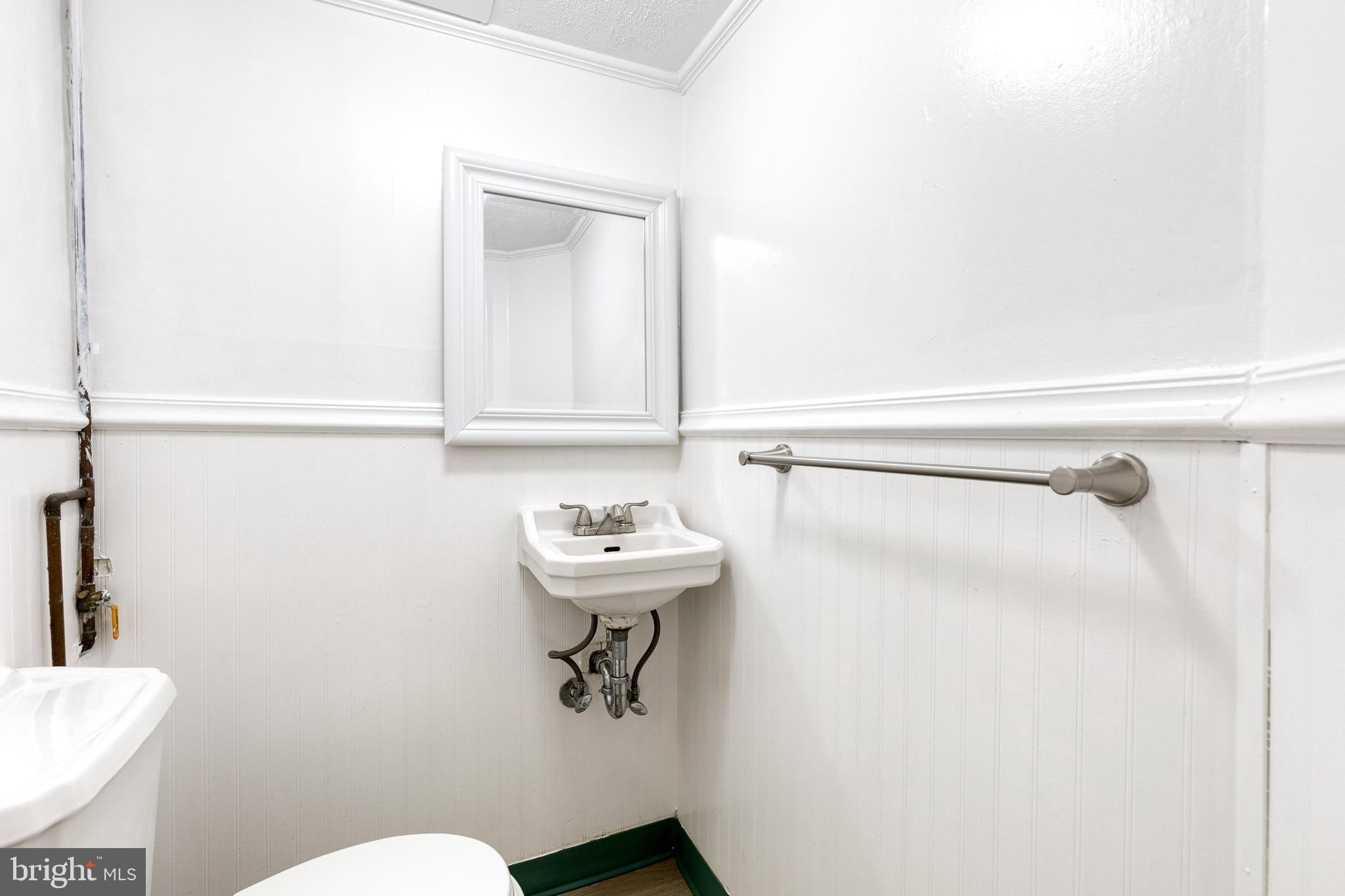 2012 Northbourne Road Baltimore, MD 21239 - Photo 34 of 35 a bathroom with a sink mirror and toilet