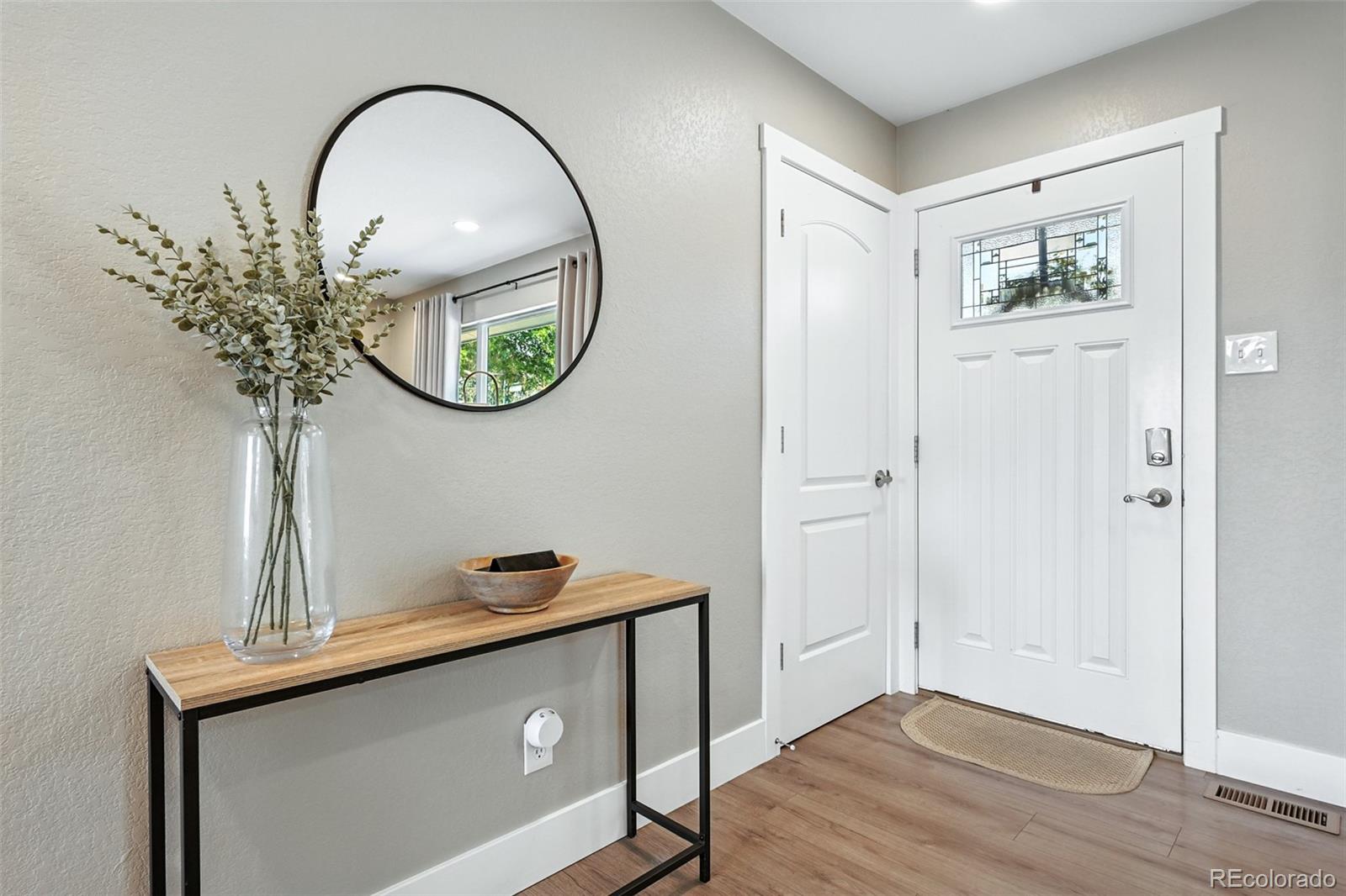 2714 South Raleigh Street Denver, CO 80236 - Photo 3 of 34 a view of a hallway with front door