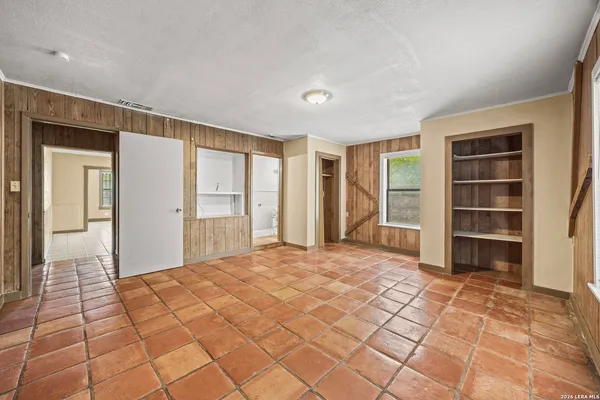 a view of empty room with wooden floor and cabinet