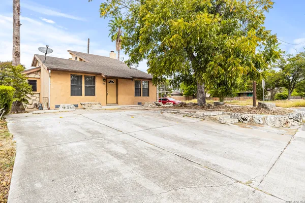 a view of a house with snow on the road