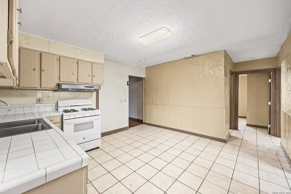 a kitchen with a stove cabinets and a refrigerator