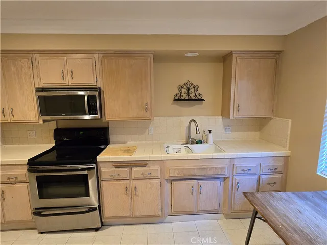 a kitchen with a sink stove and microwave