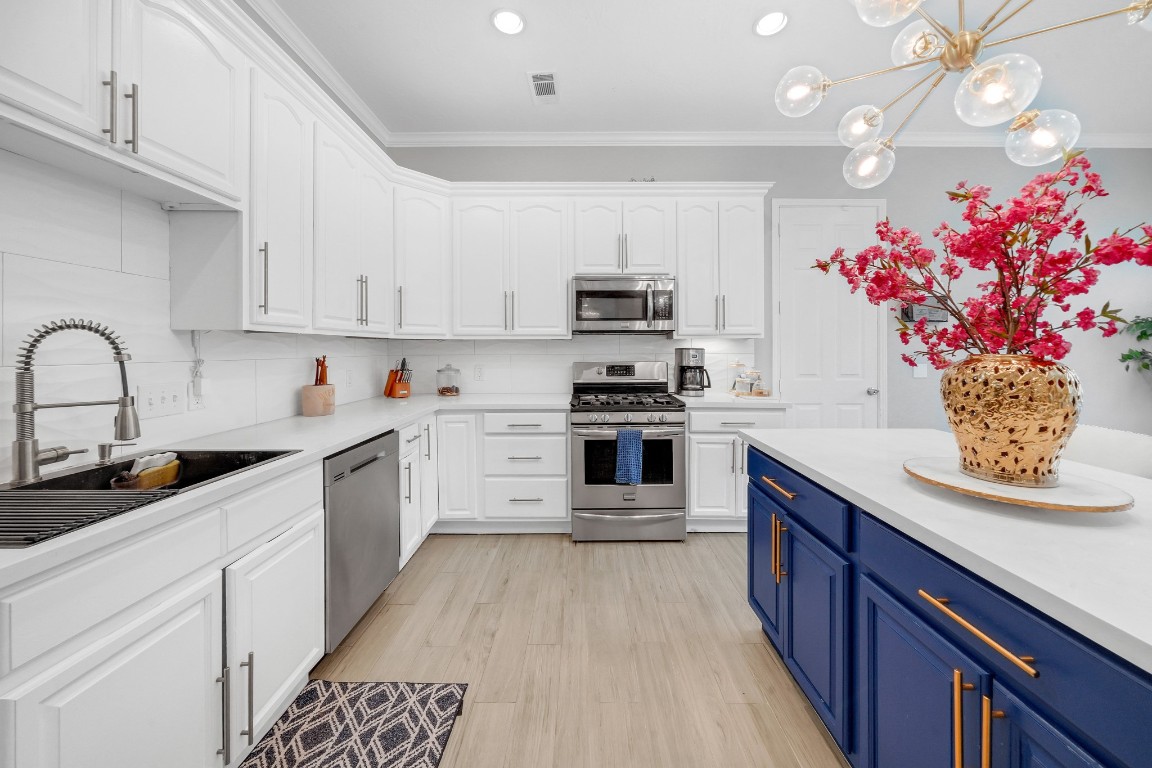 15711 Edo Circle Houston, TX 77083 - Photo 1 of 19 a kitchen with granite countertop a sink dishwasher stove and cabinets with wooden floor