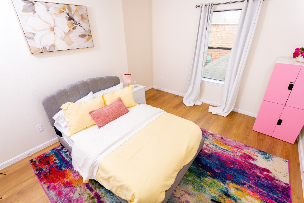 15711 Edo Circle Houston, TX 77083 - Photo 14 of 19 a bed sitting in a bedroom next to a window