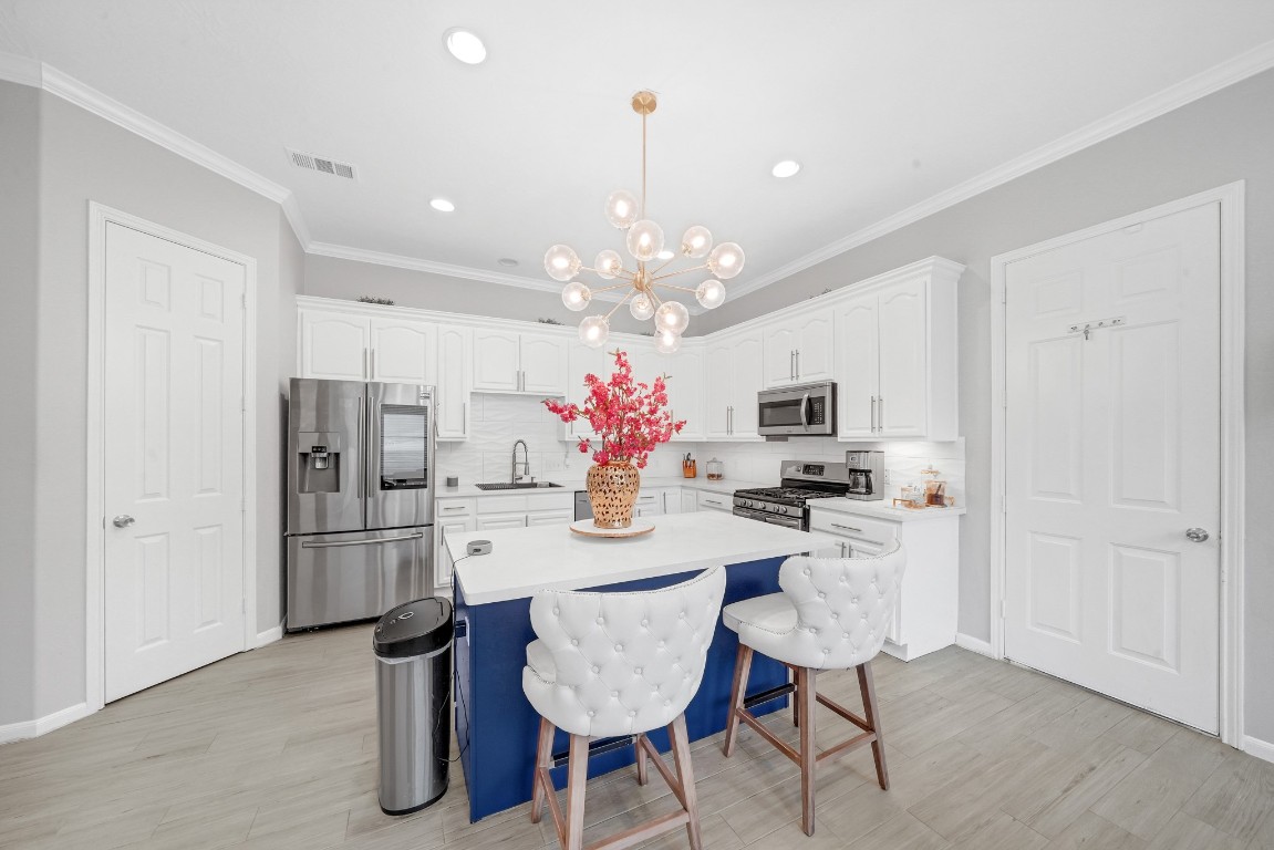 15711 Edo Circle Houston, TX 77083 - Photo 6 of 19 a dining room with stainless steel appliances furniture a chandelier and kitchen view