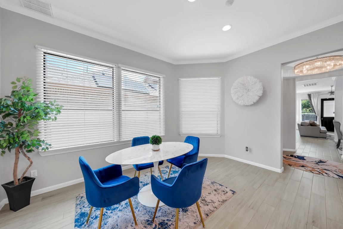 15711 Edo Circle Houston, TX 77083 - Photo 7 of 19 a view of a dining room with furniture and wooden floor