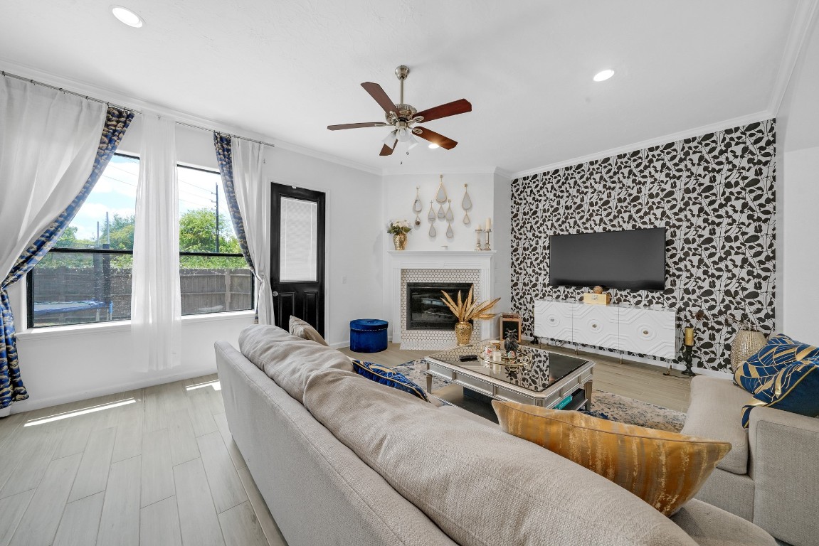 15711 Edo Circle Houston, TX 77083 - Photo 8 of 19 a living room with furniture a flat screen tv and a fireplace