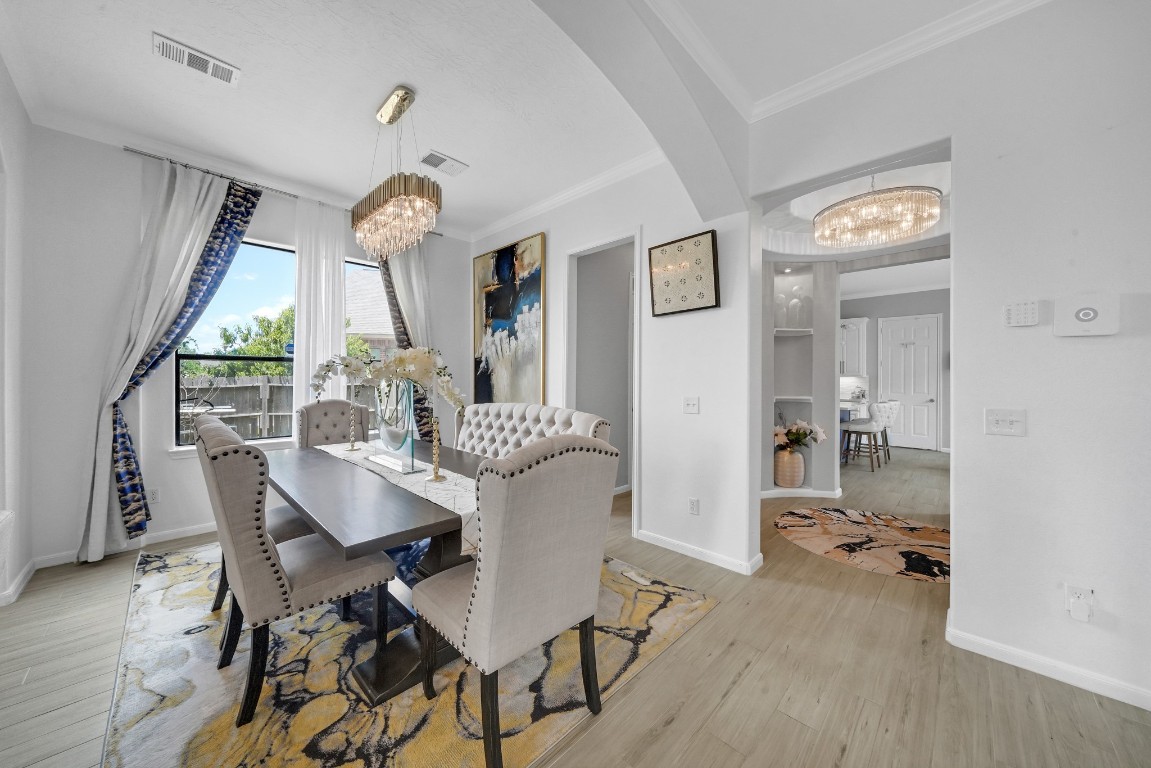 15711 Edo Circle Houston, TX 77083 - Photo 9 of 19 a view of a dining room with furniture window and wooden floor