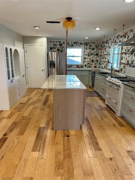 2507 East Side Drive Austin, TX 78704 - Photo 5 of 26 a kitchen with stainless steel appliances kitchen island granite countertop a sink and cabinets