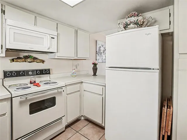 a white refrigerator freezer sitting inside of a kitchen