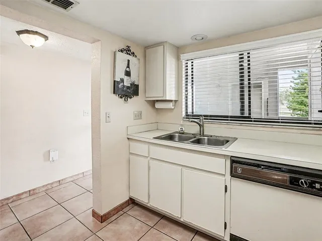 a view of a sink and dishwasher with wooden floor