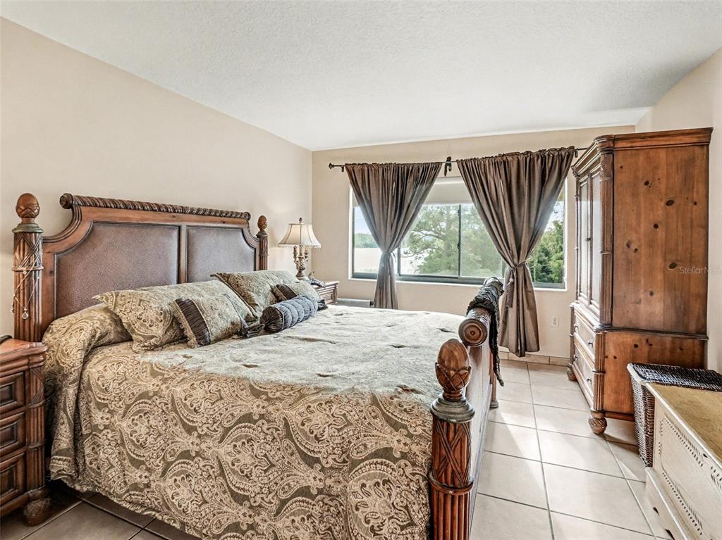 1052 Lotus Cove Court, Unit 733 Altamonte Springs, FL 32714 - Photo 14 of 28 a bedroom with a bed and large windows