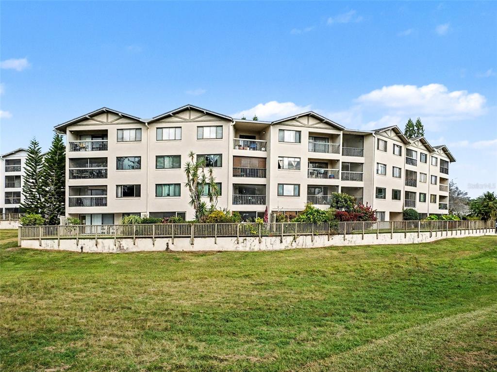 1052 Lotus Cove Court, Unit 733 Altamonte Springs, FL 32714 - Photo 22 of 28 a front view of a building with a yard