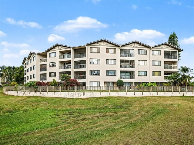 a front view of a building with a garden