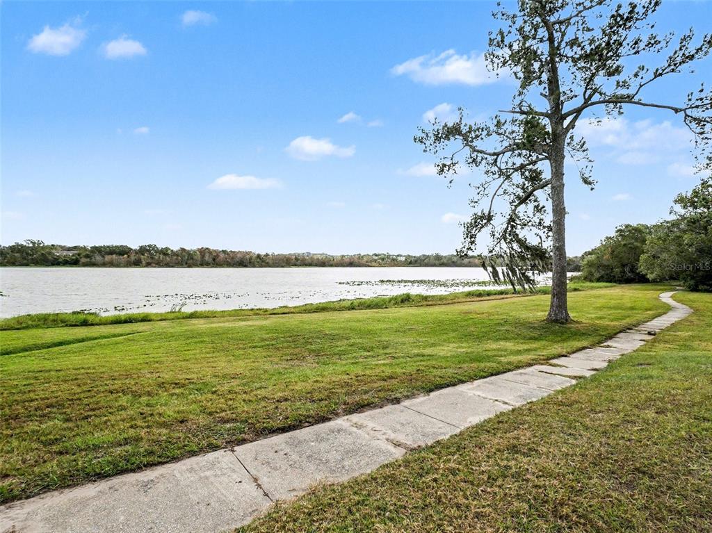 1052 Lotus Cove Court, Unit 733 Altamonte Springs, FL 32714 - Photo 26 of 28 a view of a lake with a big yard