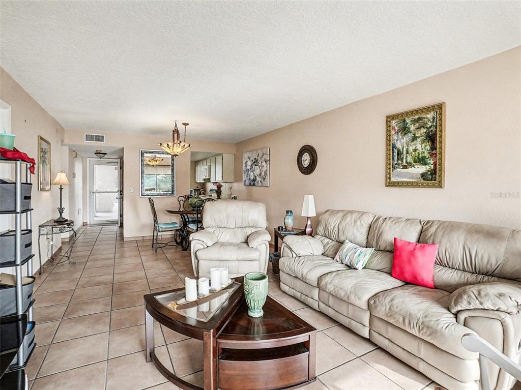 1052 Lotus Cove Court, Unit 733 Altamonte Springs, FL 32714 - Photo 5 of 28 a living room with furniture and a couch