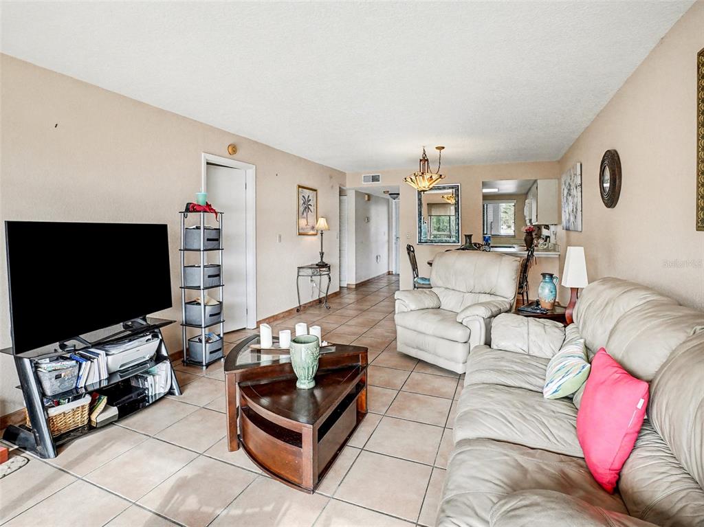 1052 Lotus Cove Court, Unit 733 Altamonte Springs, FL 32714 - Photo 6 of 28 a living room with furniture and a flat screen tv