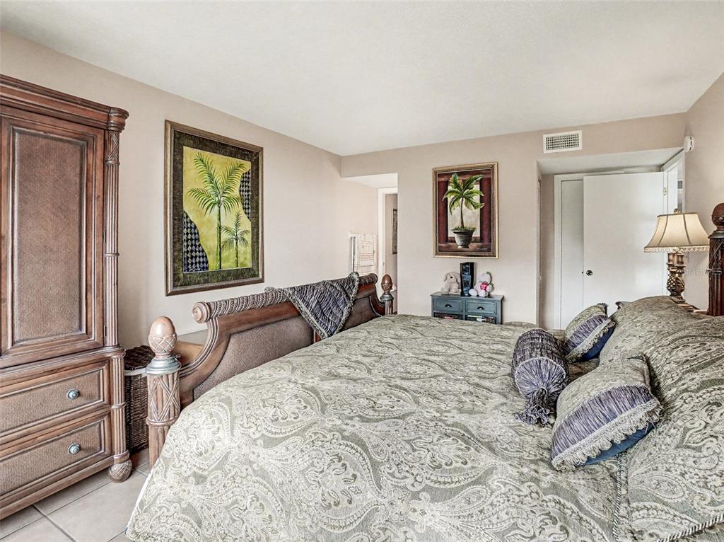 1052 Lotus Cove Court, Unit 733 Altamonte Springs, FL 32714 - Photo 8 of 28 a bedroom with a bed and wooden floor