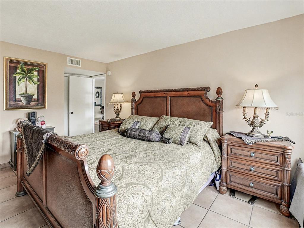 1052 Lotus Cove Court, Unit 733 Altamonte Springs, FL 32714 - Photo 9 of 28 a bedroom with a bed and dresser