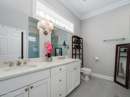 a bathroom with a sink vanity mirror bathtub and toilet