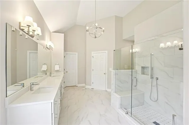 a bathroom with a sink a mirror and shower