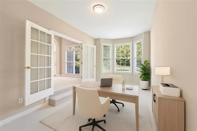 a view of a livingroom with workspace and a window
