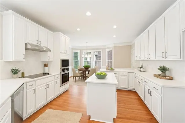 a kitchen with sink stove top oven and cabinets