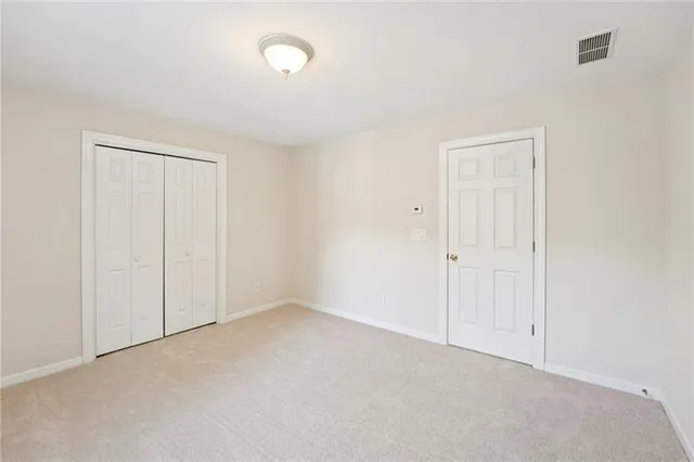a view of a room with wooden walls and windows