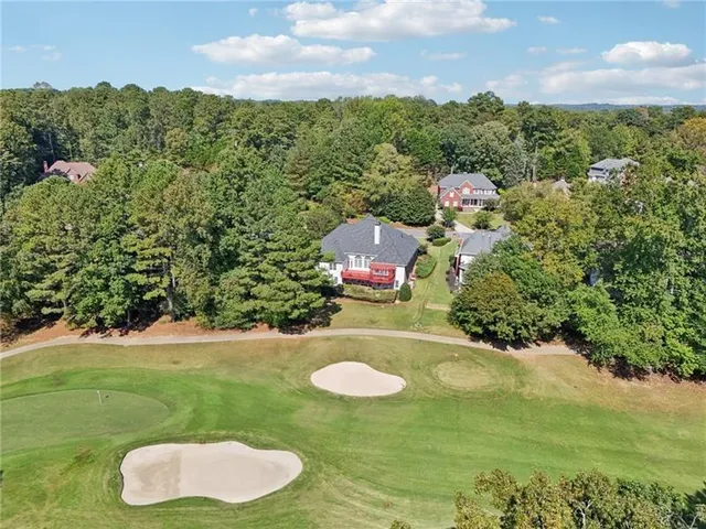 an aerial view of a house with garden space and street view