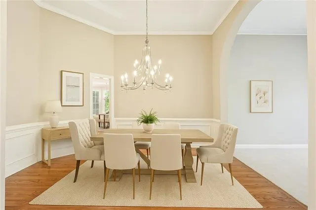 a view of a dining room with furniture and chandelier