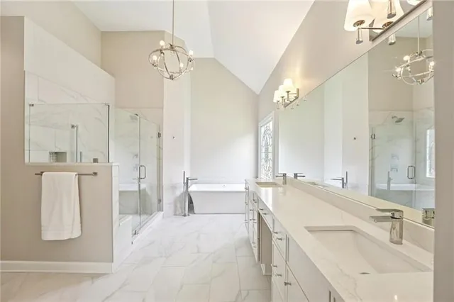 a spacious bathroom with a sink a large mirror and a shower