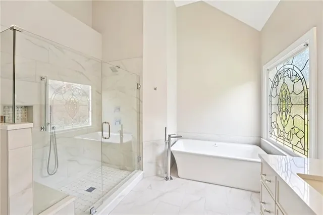 a bathroom with a bathtub and a shower