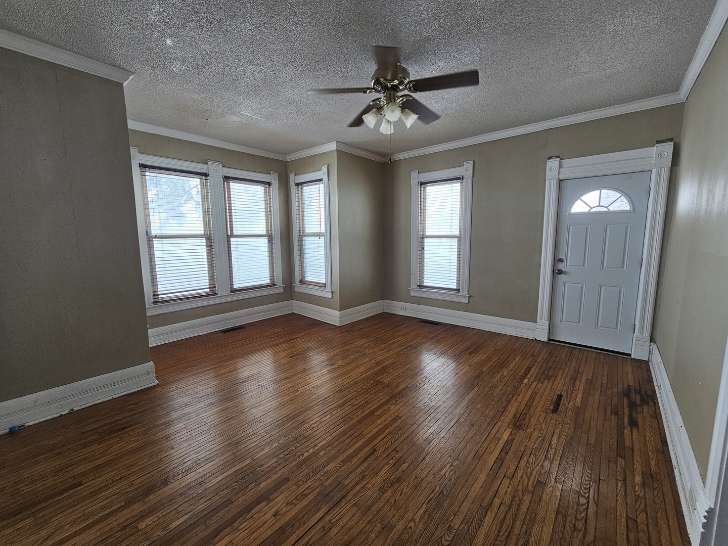 3926 East 1750th Road Sheridan, IL 60551 - Photo 3 of 23 a view of an empty room with wooden floor and a window