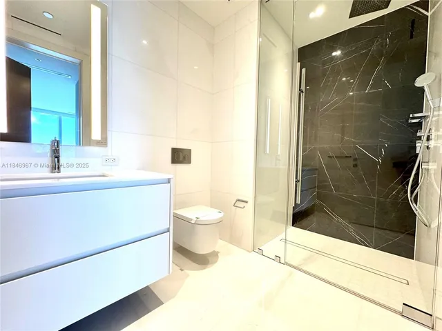 a bedroom with two beds and large window