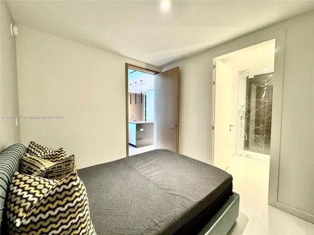 a bedroom with a bed and table