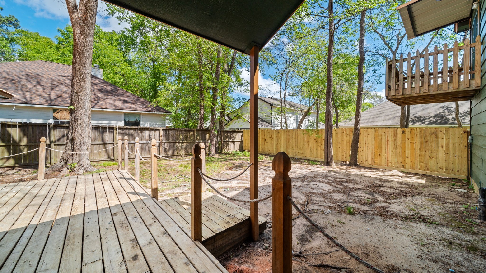 417 Shawnee Conroe, TX 77316 - Photo 16 of 18 Enjoy sitting on your back deck with mature trees in the fenced backyard.