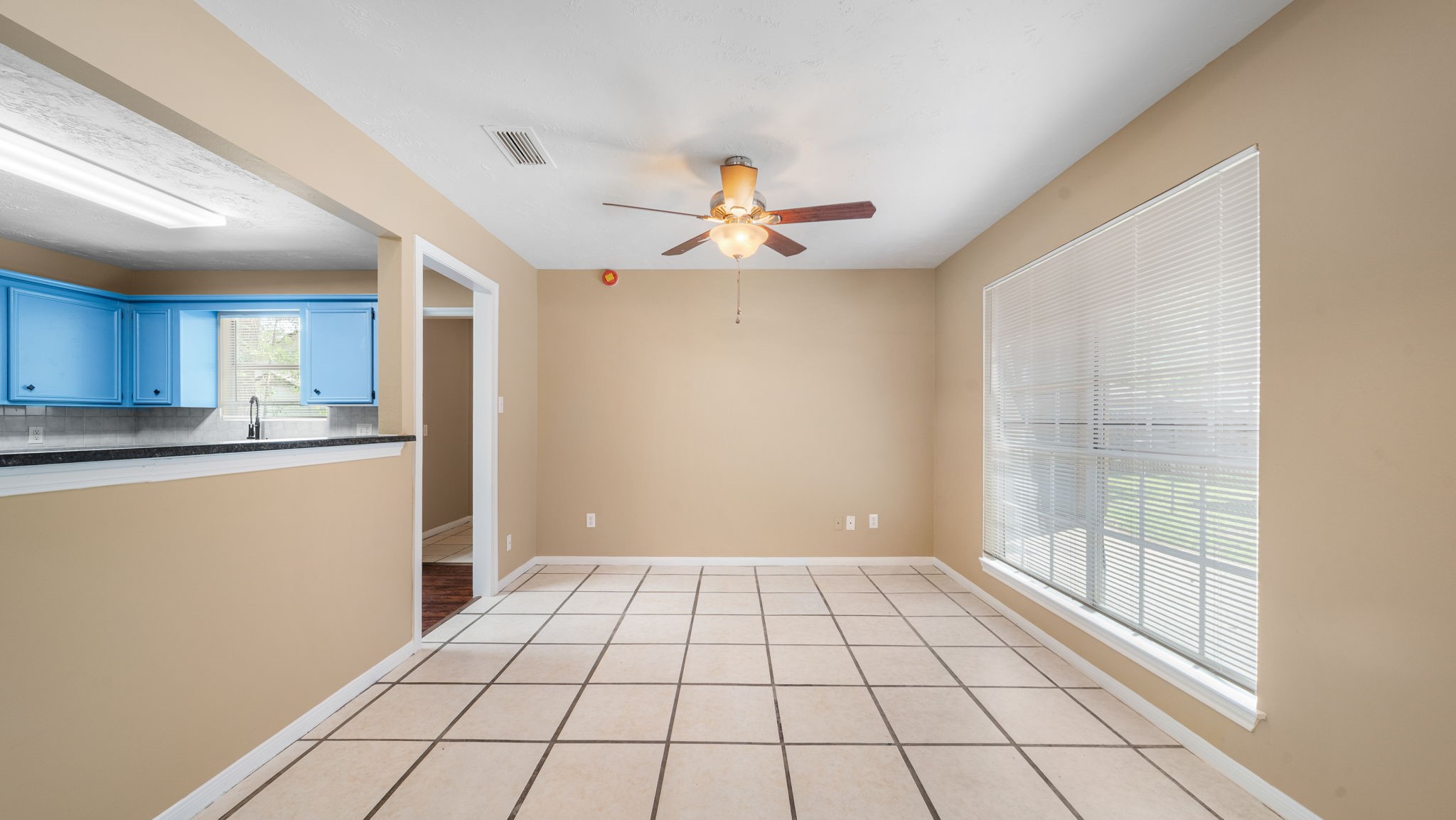 417 Shawnee Conroe, TX 77316 - Photo 8 of 18 Open dining area with large window and seamless flow into main living space.