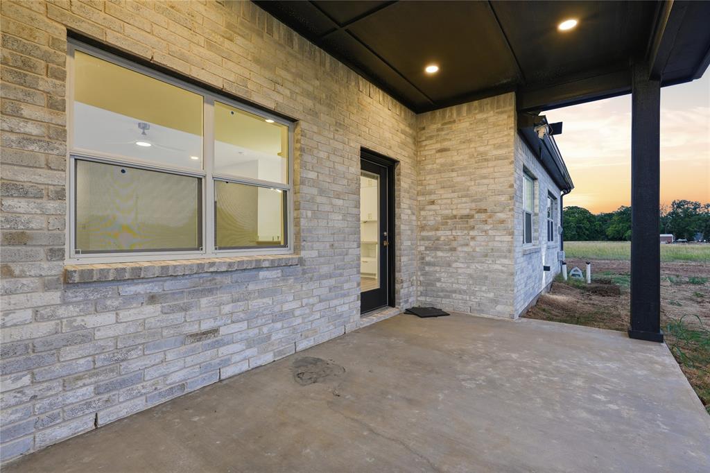 130 Cedar Elm Road Trinidad, TX 75163 - Photo 22 of 27 Covered concrete patio featuring recessed lighting, a black support column, and light-colored brick exterior