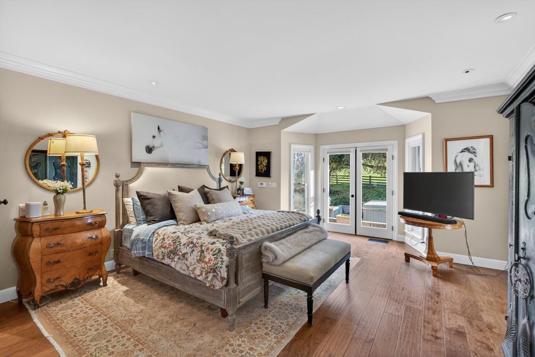 3970 Leavesley Road Gilroy, CA 95020 - Photo 26 of 52 a bedroom with a bed and a flat screen tv