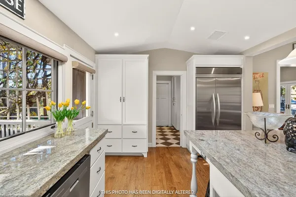 a kitchen with stainless steel appliances granite countertop a refrigerator and a sink