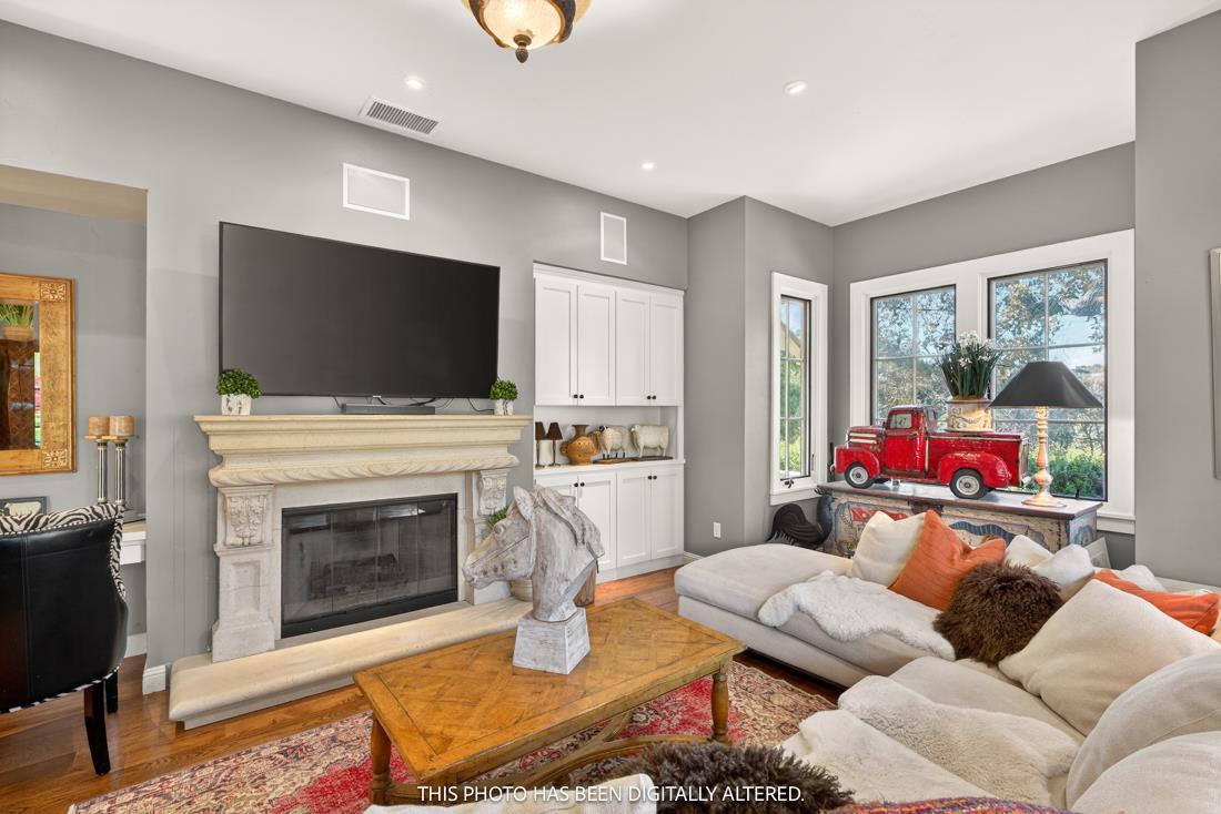 3970 Leavesley Road Gilroy, CA 95020 - Photo 48 of 52 a living room with furniture a flat screen tv and a fireplace
