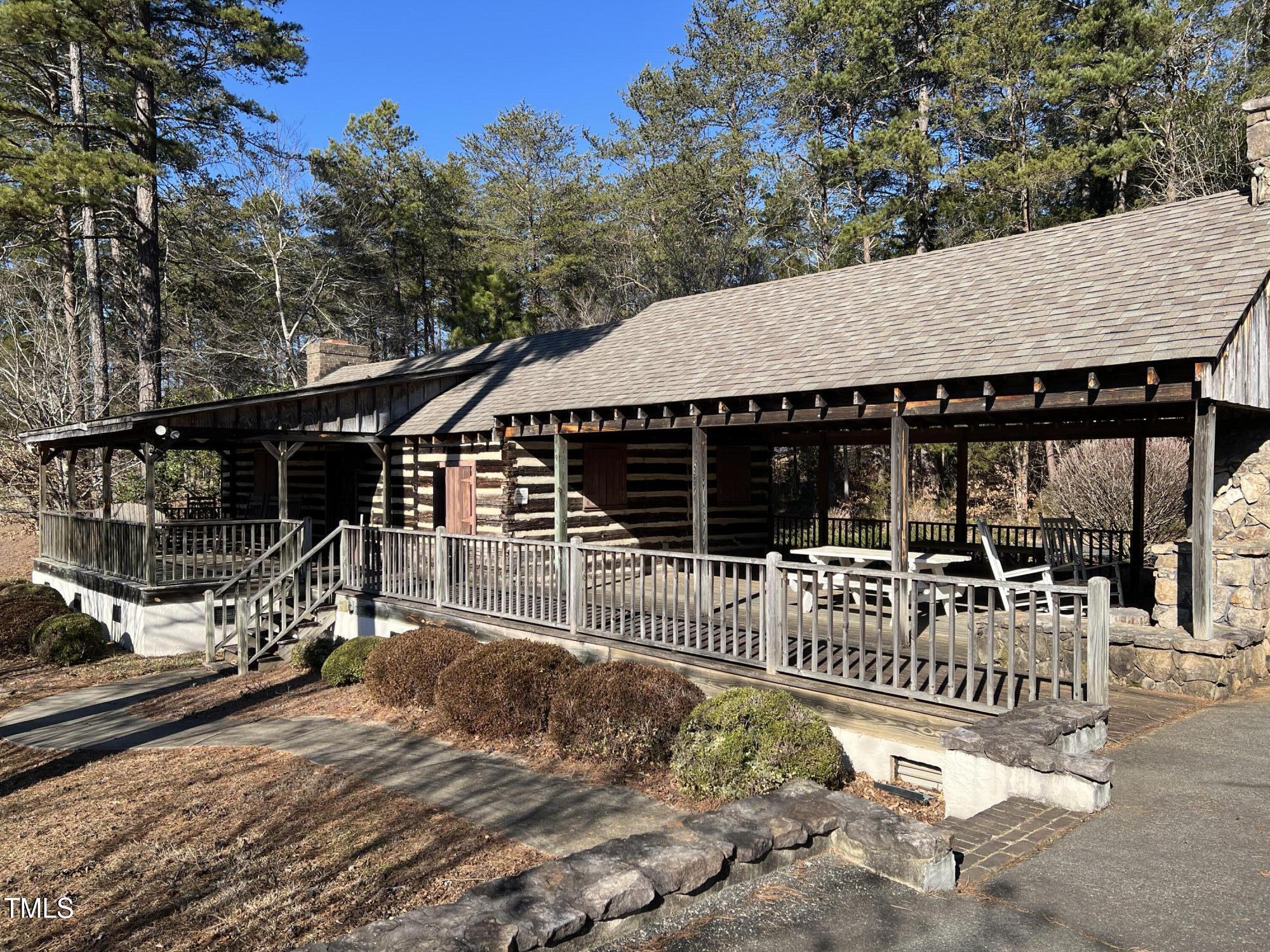 4524 West Millstone Drive Burlington, NC 27215 - Photo 15 of 22 a view of house with deck outdoor seating and covered with trees