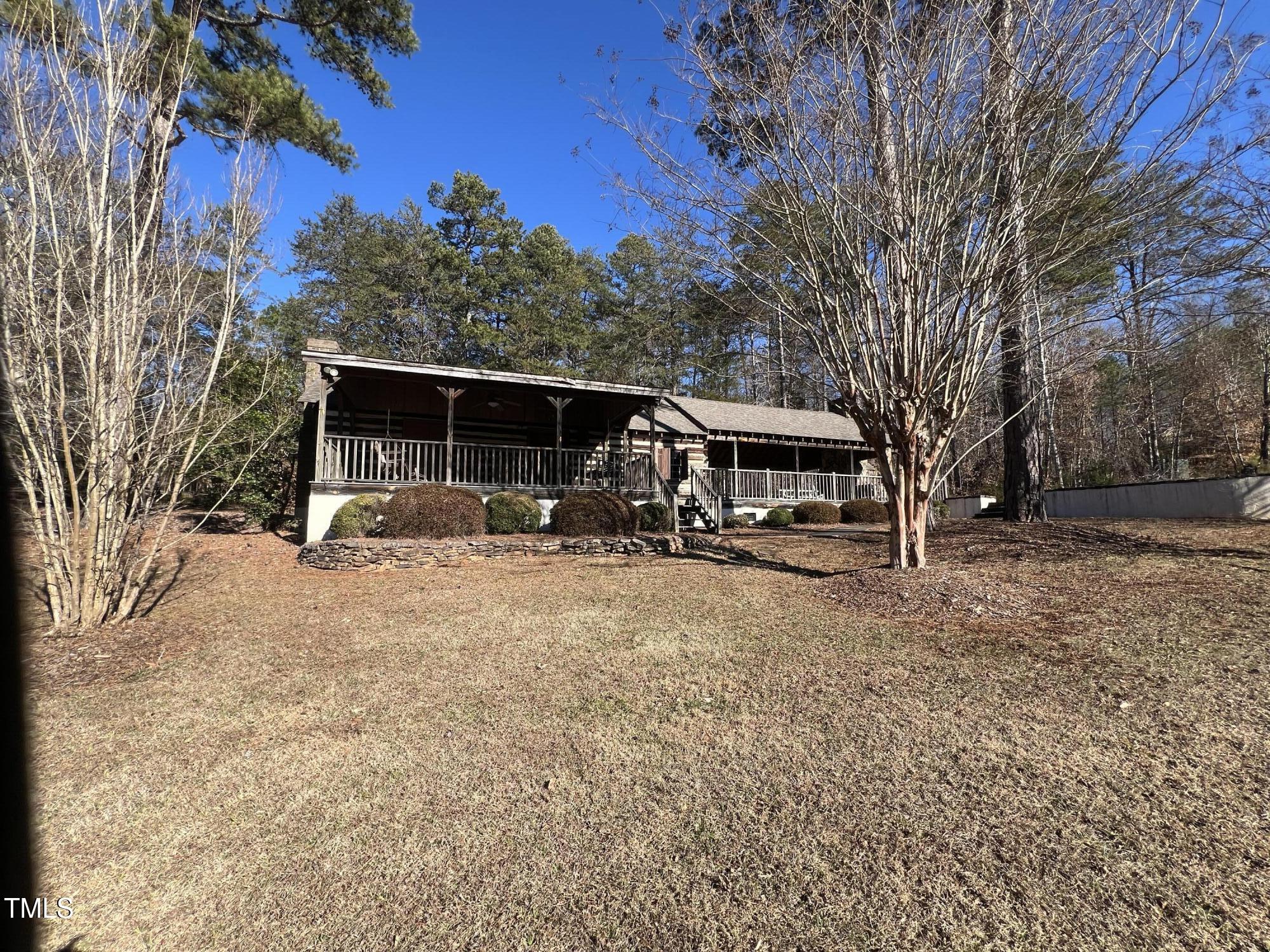 4524 West Millstone Drive Burlington, NC 27215 - Photo 20 of 22 a view of a house with a yard covered in the forest
