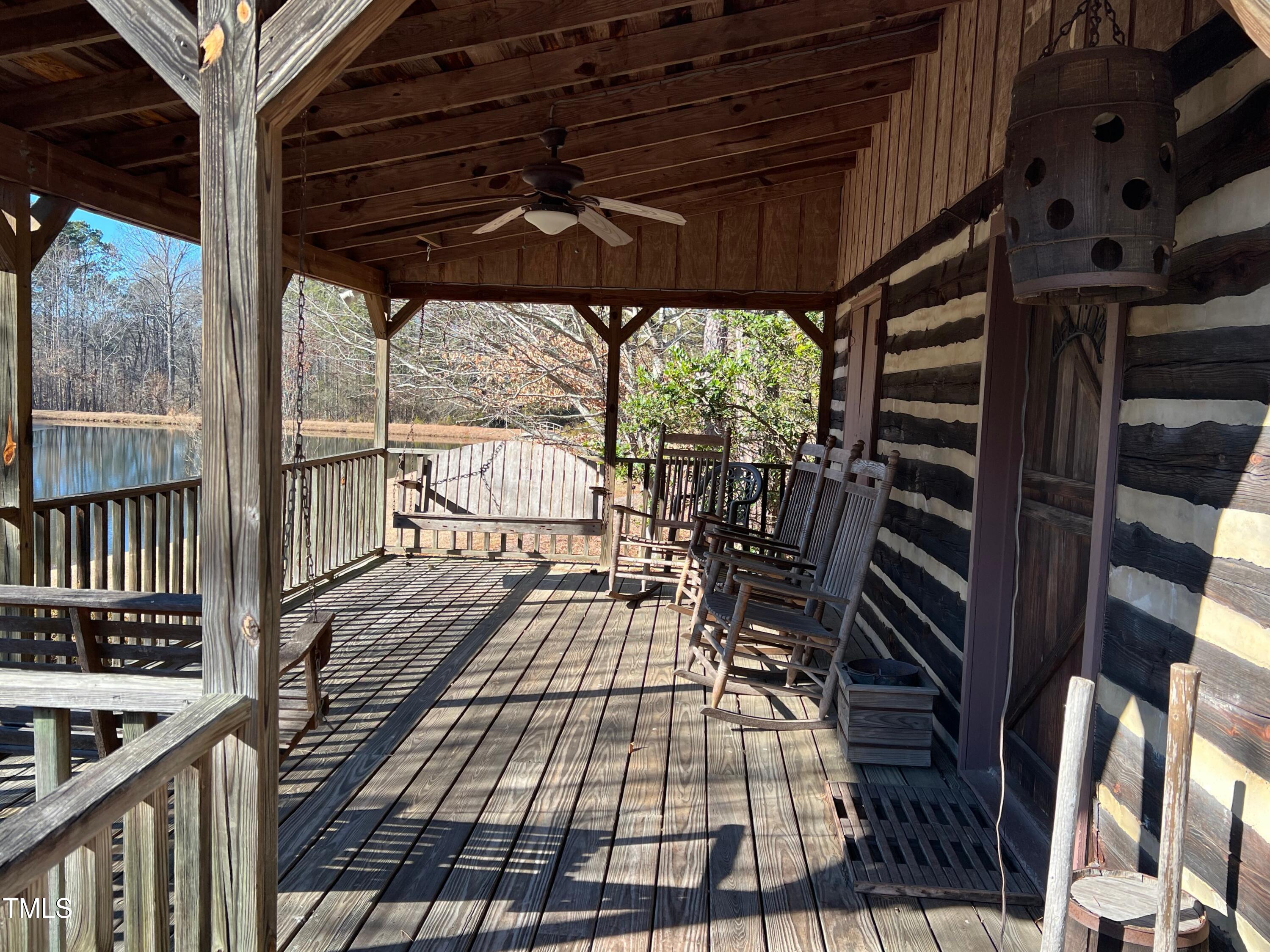 4524 West Millstone Drive Burlington, NC 27215 - Photo 21 of 22 a view of a balcony with furniture and wooden floor